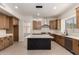 Modern kitchen with stainless steel appliances, an island, custom cabinets, and recessed lighting at 7179 W Surrey Ave, Peoria, AZ 85381