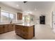 Modern kitchen featuring an island, stainless steel appliances, and ample natural light from large windows at 7179 W Surrey Ave, Peoria, AZ 85381