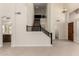 View of living room, stairs, chandelier, and entrance to a downstairs bathroom at 7179 W Surrey Ave, Peoria, AZ 85381