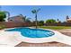 Inviting backyard pool with surrounding patio, landscaping, and secure fencing at 7179 W Surrey Ave, Peoria, AZ 85381