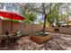 Spacious backyard with a charming bench, vibrant flower planter, and a built-in outdoor grill, perfect for relaxing at 7202 N 16Th Dr, Phoenix, AZ 85021