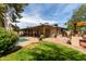 Expansive backyard featuring a covered patio, lush lawn, and inviting pool, perfect for outdoor living and entertaining at 7202 N 16Th Dr, Phoenix, AZ 85021