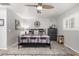 Comfortable bedroom featuring neutral colors, a decorative rug, and a large window with shutter blinds at 7202 N 16Th Dr, Phoenix, AZ 85021