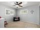 This Bedroom features gray walls, carpet, a ceiling fan, and a view of the neighborhood at 7202 N 16Th Dr, Phoenix, AZ 85021