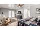 This light-filled main bedroom features hardwood floors, two chairs, and an ensuite bath at 7202 N 16Th Dr, Phoenix, AZ 85021