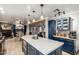 Open-concept kitchen with island seating, modern appliances, and seamless flow to dining and living areas at 7202 N 16Th Dr, Phoenix, AZ 85021
