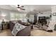 Bright living room featuring a large sectional sofa, wood floors, plantation shutters, and stylish decor at 7202 N 16Th Dr, Phoenix, AZ 85021