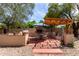 Outdoor kitchen and dining area with built-in brick barbecue, pergola, and cozy seating, ideal for al fresco dining at 7202 N 16Th Dr, Phoenix, AZ 85021