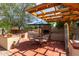 Outdoor kitchen featuring a built-in barbecue, and pergola, creating the perfect outdoor dining space at 7202 N 16Th Dr, Phoenix, AZ 85021