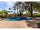Lush backyard oasis features a sparkling pool with waterfall features, surrounded by mature trees and landscaping for privacy at 7202 N 16Th Dr, Phoenix, AZ 85021