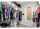 This walk-in closet features shelving for bags and shoes and ample hanging space at 7202 N 16Th Dr, Phoenix, AZ 85021