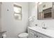 Well-lit bathroom featuring a white vanity, a mirror, and a frosted window at 7210 N 17Th Ave, Phoenix, AZ 85021