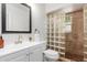Bright bathroom features glass block shower, neutral tile, and contemporary mirror at 7210 N 17Th Ave, Phoenix, AZ 85021