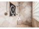 Elegant bathroom featuring travertine tile and decorative tile in shower at 7210 N 17Th Ave, Phoenix, AZ 85021