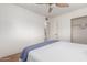Bedroom featuring carpet and ceiling fan, accompanied by a walk-in closet at 7210 N 17Th Ave, Phoenix, AZ 85021