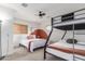 Bedroom featuring a bunk bed, a single bed, and natural light streaming through the window at 7210 N 17Th Ave, Phoenix, AZ 85021