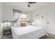 Relaxing bedroom featuring a comfortable bed, ceiling fan, and decorative artwork at 7210 N 17Th Ave, Phoenix, AZ 85021
