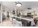 Inviting dining area with a long wooden table, white chairs, and views of the kitchen and living areas at 7210 N 17Th Ave, Phoenix, AZ 85021
