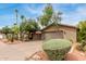 A view of the home's exterior showcasing desert landscaping, garage, and a well-maintained yard at 7210 N 17Th Ave, Phoenix, AZ 85021