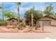 Charming desert landscaping enhances this single-story home with a two-car garage and red rock accents at 7210 N 17Th Ave, Phoenix, AZ 85021