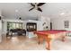 Expansive game room with a pool table and view of an adjacent living area and fireplace at 7210 N 17Th Ave, Phoenix, AZ 85021