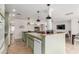 Charming eat-in kitchen featuring an island, granite countertops, and complementary pendant lighting at 7210 N 17Th Ave, Phoenix, AZ 85021