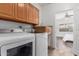 Well-equipped laundry room with washer, dryer, cabinetry, and access to bedroom at 7210 N 17Th Ave, Phoenix, AZ 85021