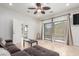 Spacious living room with a ceiling fan, natural lighting, and tile flooring at 7210 N 17Th Ave, Phoenix, AZ 85021