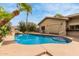 Private pool features rock waterfall, palm trees, and ample deck space at 7210 N 17Th Ave, Phoenix, AZ 85021