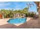 Backyard pool with rock waterfall feature and mature landscaping at 7210 N 17Th Ave, Phoenix, AZ 85021