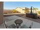Backyard patio area with a small table, chairs, and a hot tub at 7577 S Towel Creek Dr, Gold Canyon, AZ 85118