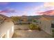 Private backyard featuring a gravel landscape, block wall fencing, and mountain views in the distance at 7577 S Towel Creek Dr, Gold Canyon, AZ 85118