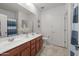 Bathroom featuring a double vanity sink, floral decor, and tile flooring at 7577 S Towel Creek Dr, Gold Canyon, AZ 85118