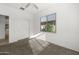 Bedroom with carpet, a ceiling fan, and a large window providing natural light and outside view at 7577 S Towel Creek Dr, Gold Canyon, AZ 85118