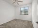 Bright bedroom with neutral carpet, ceiling fan, and a window offering natural light at 7577 S Towel Creek Dr, Gold Canyon, AZ 85118