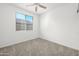 Neutral bedroom with a ceiling fan and a window letting in natural light at 7577 S Towel Creek Dr, Gold Canyon, AZ 85118
