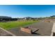 Community area with a horseshoe pit, lush green lawns, and mountain views, promoting an active lifestyle at 7577 S Towel Creek Dr, Gold Canyon, AZ 85118