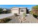 Charming home featuring desert landscaping, a two-car garage, and a welcoming walkway at 7577 S Towel Creek Dr, Gold Canyon, AZ 85118