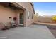 Charming covered patio with a table, chairs, and desert landscaping at 7577 S Towel Creek Dr, Gold Canyon, AZ 85118