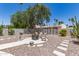 Backyard featuring desert landscaping, a fire pit with chairs, and an ornamental metal screen and desert foliage at 7736 E Rancho Vista Dr, Scottsdale, AZ 85251