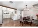 Charming kitchen and dining area with white cabinets, wood beam accents, and modern appliances at 7736 E Rancho Vista Dr, Scottsdale, AZ 85251