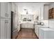 Spacious kitchen with white cabinets, stainless steel appliances, and a large window at 7736 E Rancho Vista Dr, Scottsdale, AZ 85251