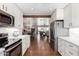 Bright, open kitchen with stainless steel appliances, white cabinetry and views into the dining room and living spaces at 7736 E Rancho Vista Dr, Scottsdale, AZ 85251