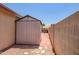 Backyard with shed and brick path along a brick wall at 8178 W Tonopah Dr, Peoria, AZ 85382