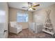Bright Bedroom featuring a white crib, rocker and teepee-style shelving unit with decorations at 8178 W Tonopah Dr, Peoria, AZ 85382