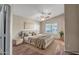Calm and inviting bedroom with ceiling fan, neutral colors, and a large window letting in natural light at 8178 W Tonopah Dr, Peoria, AZ 85382