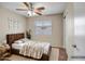 Cozy bedroom featuring a wooden bed frame, floral patterned throw blanket, and neutral walls at 8178 W Tonopah Dr, Peoria, AZ 85382