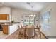 Bright dining room with a rustic table, modern chandelier, and sliding glass doors to the backyard at 8178 W Tonopah Dr, Peoria, AZ 85382