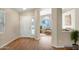 Bright entryway with hardwood floors and view to living area with ample natural light and neutral decor at 8178 W Tonopah Dr, Peoria, AZ 85382