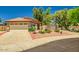 Charming single-story home featuring a tile roof, desert landscaping, and a two-car garage at 8178 W Tonopah Dr, Peoria, AZ 85382